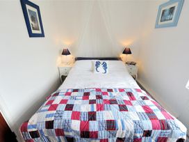 A bedroom with a double bed and bedside tables at 1 The Old Posthouse, Lyme Regis