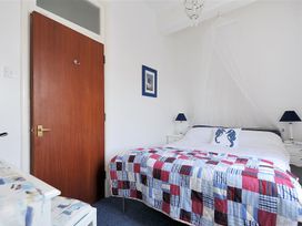 A bedroom with a bed and bedside tables at 1 The Old Posthouse in Lyme Regis