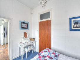 A bedroom with a dresser and bed at 1 The Old Posthouse in Lyme Regis