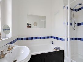 A bathroom with a bathtub and shower at 1 The Old Posthouse in Lyme Regis