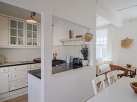 A kitchen with stove and sink at 1 The Old Posthouse in Lyme Regis