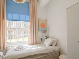 A bedroom with a bed and a window at 1 The Old Posthouse in Lyme Regis