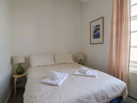 A bedroom with a bed and bedside lamp at 1 The Old Posthouse in Lyme Regis