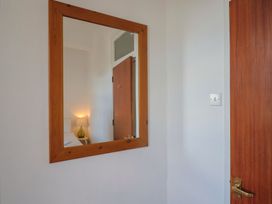 A mirror and a door in a bedroom at 1 The Old Posthouse in Lyme Regis