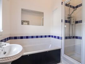 A bathroom with a bath tub and shower at 1 The Old Posthouse in Lyme Regis
