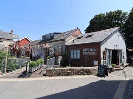 A microbrewery building with a sign and pathway at 1 The Old Posthouse Lyme Regis
