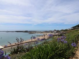 A view of a beach with boats in the water at 1 The Old Posthouse in Lyme Regis