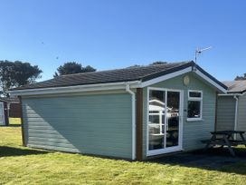 A cabin with a table and seats outside at Embury 