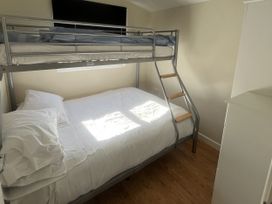 A bedroom with a bunk bed and a double bed at Embury