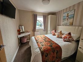 A bedroom with a bed and dressing table at 38A in Bridlington
