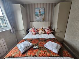 A bedroom with a bed and wardrobe at 38A in Bridlington