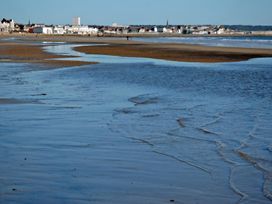 A beach with water and buildings in the background at 38A in Bridlington
