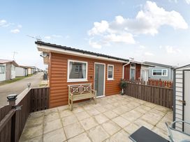 A cabin with outdoor seating area at 38A Bridlington