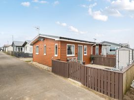 A house with a wooden fence and a shed at 38A in Bridlington