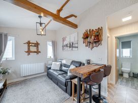 A living room with a sofa and bar stools at 38A in Bridlington