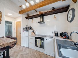 A kitchen with appliances and wooden features at 38A in Bridlington