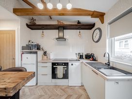 A kitchen with cabinets, appliances, and a sink at 38A in Bridlington