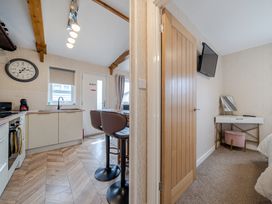 A kitchen with a sink and stools at 38A in Bridlington