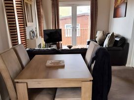 A living room with a table and sofa at 311 Bridlington