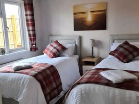 A bedroom with two beds and a bedside table at 311 in Bridlington