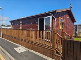 A house with a deck and fenced area at 311 Bridlington