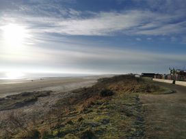 A beach with people walking in the distance at 311 Bridlington