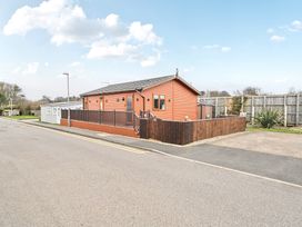 A house with a wooden fence and driveway at 311 Bridlington