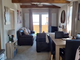 A living room with sofa and dining area at 50 Bridlington