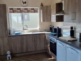 A kitchen with cabinets, sink, and appliances at 50 Bridlington