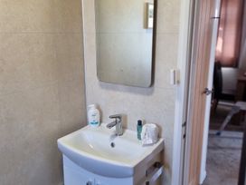 A bathroom with a sink and mirror at 50 Bridlington