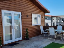 An outdoor patio with a table and chairs at 50 Bridlington