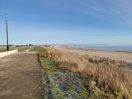 A beach with a pathway and ocean at 50 Bridlington