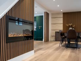 A dining room with an electric fireplace and dining table at The Galloway in Morpeth