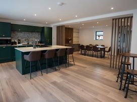 A kitchen with an island and dining area at The Galloway in Morpeth