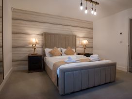 A bedroom with a bed and bedside tables at The Galloway in Morpeth