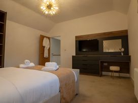 A bedroom with a bed and television at The Galloway in Morpeth