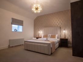 A bedroom with a bed and bedside table at The Galloway in Morpeth