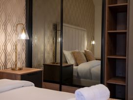 A bedroom with a bed and lamp at The Galloway in Morpeth