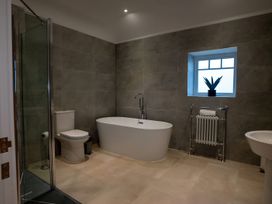 A bathroom with a bathtub, toilet, sink, and shower at The Galloway in Morpeth