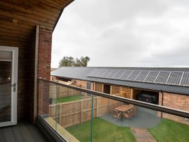 A balcony view overlooking a garden with solar panels at The Galloway in Morpeth