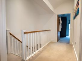 A hallway with a staircase and door at The Galloway in Morpeth