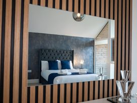 A bedroom featuring a bed with blue pillows and towels at The Galloway in Morpeth