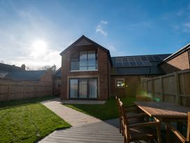 A garden with a house and patio seating at The Galloway in Morpeth