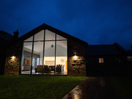 A house exterior with large windows and pathway at The Shearling in Morpeth