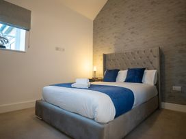 A bedroom with a bed and nightstand at The Shearling in Morpeth