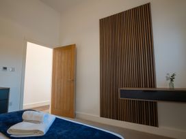 A bedroom with a bed and a door at The Shearling in Morpeth