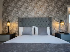A bedroom with a bed and bedside tables at The Shearling in Morpeth
