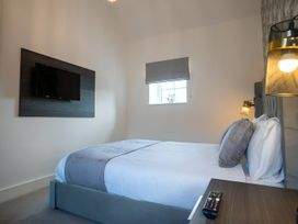 A bedroom with a bed and a television at The Shearling in Morpeth