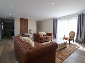 A living room with sofas and an armchair at The Newland in Morpeth