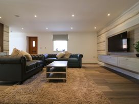 A living room with a sofa and television at The Newland in Morpeth